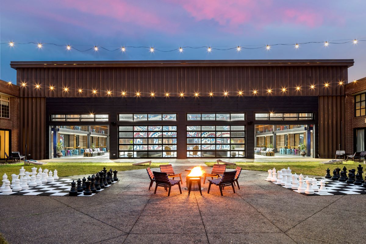 a large building with a fire pit and chess pieces