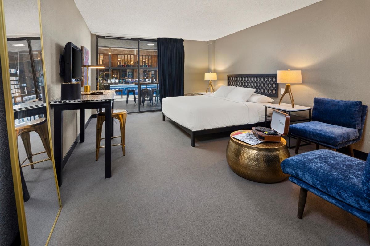 a room with a bed and a television