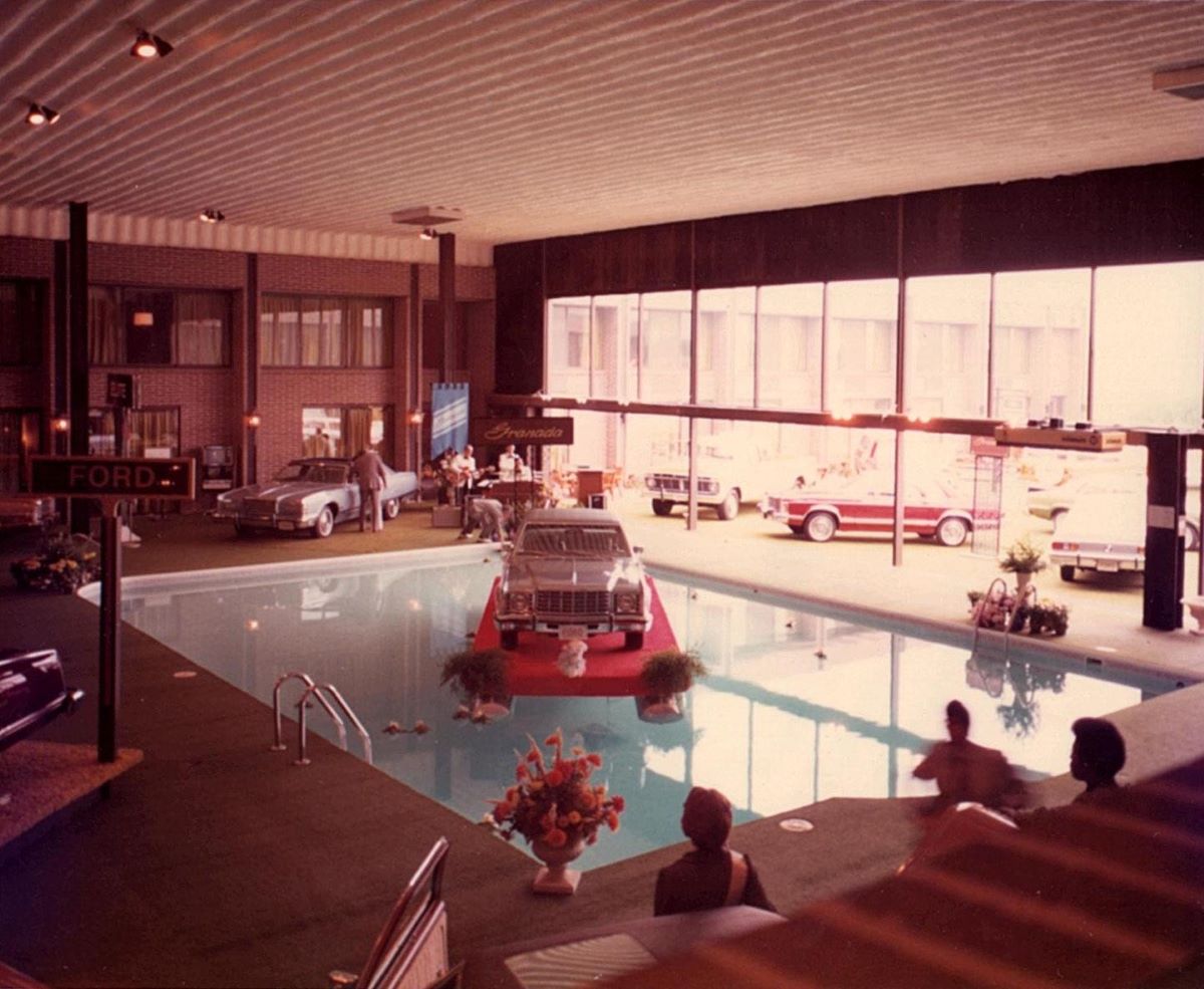 a pool with cars and people in it