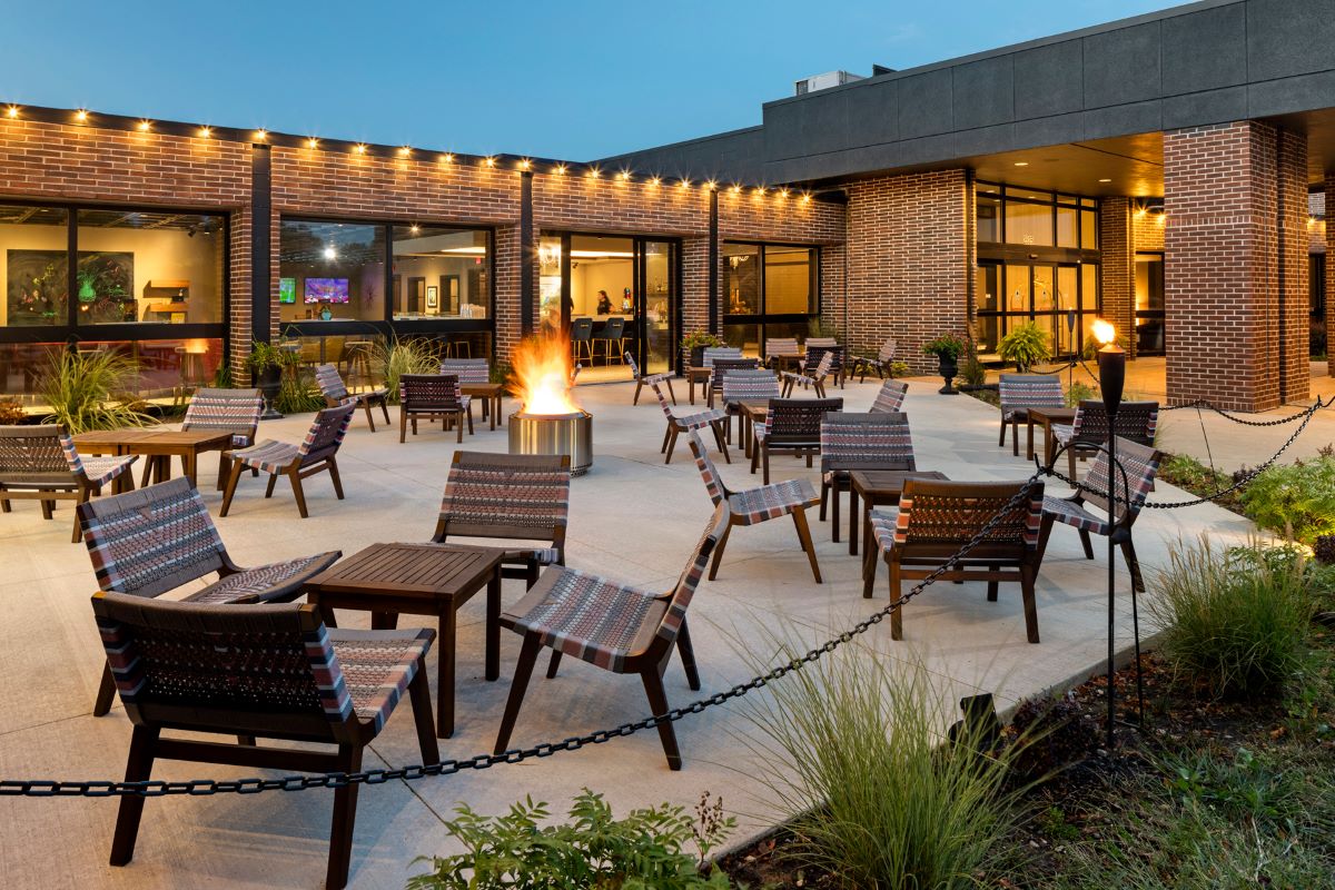 a patio with chairs and fire pit