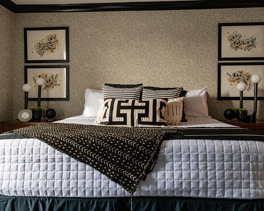 a bed with a black and white blanket