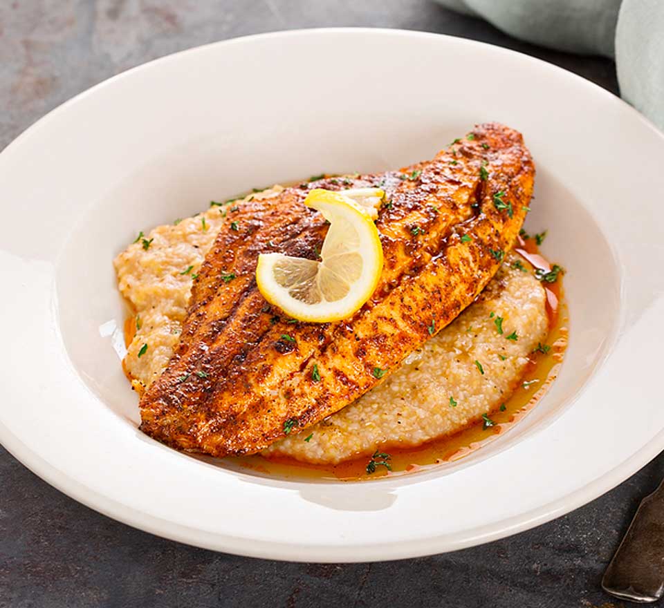a plate of food with a lemon wedge on top