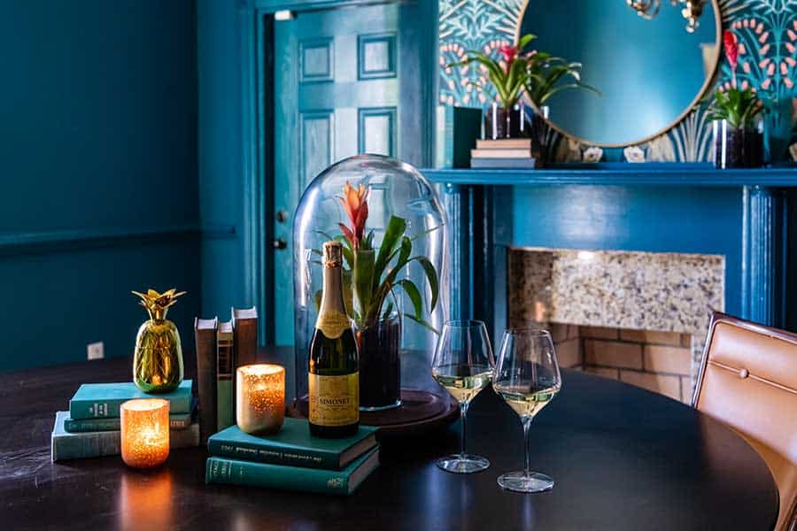 a table with wine glasses and a vase of flowers