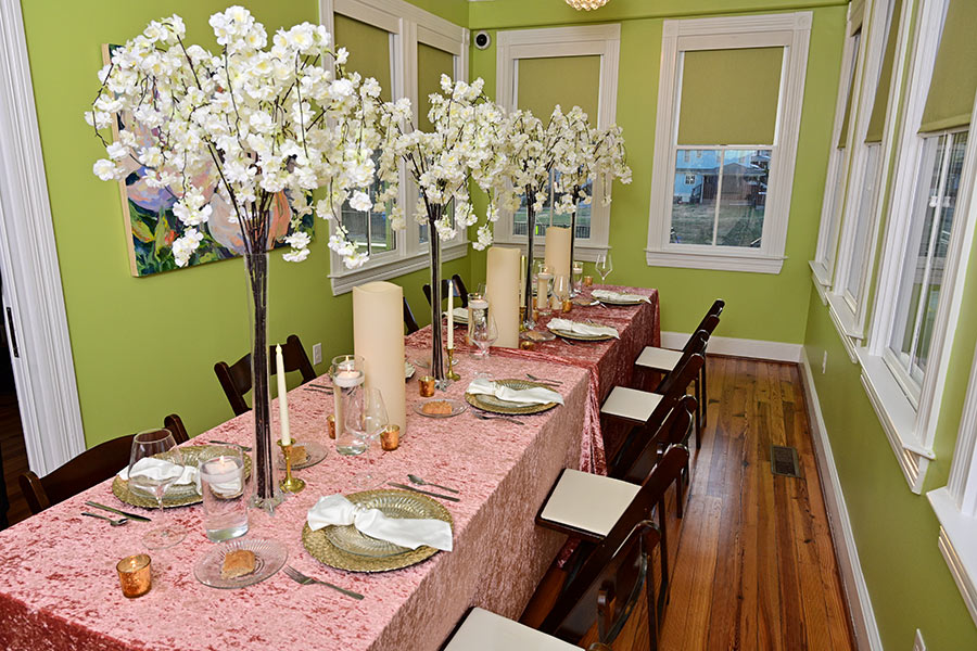 a table with white flowers and candles