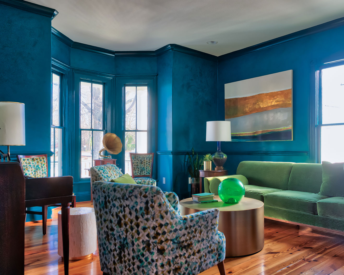 a living room with blue walls and a couch and a table