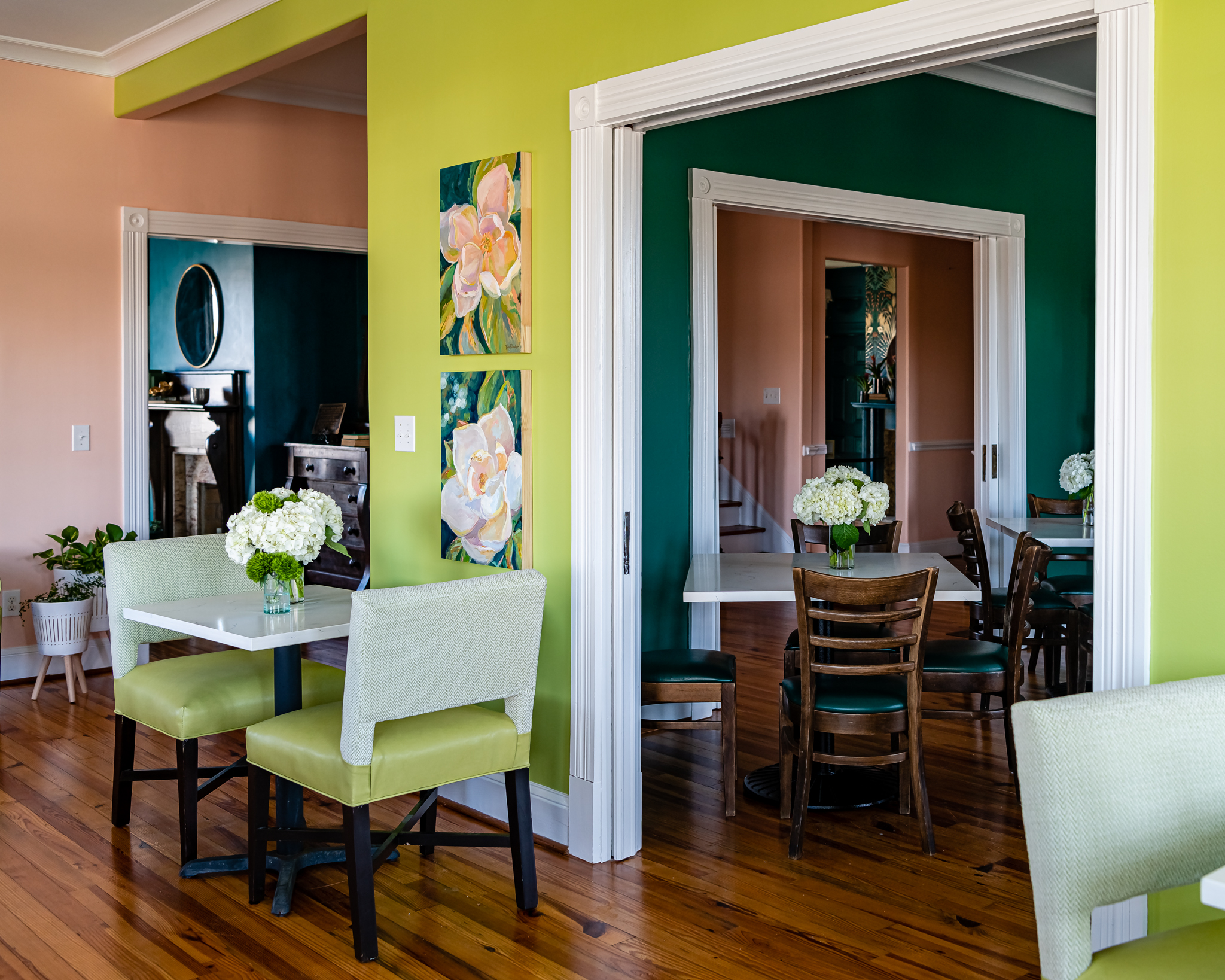 a room with green walls and white chairs