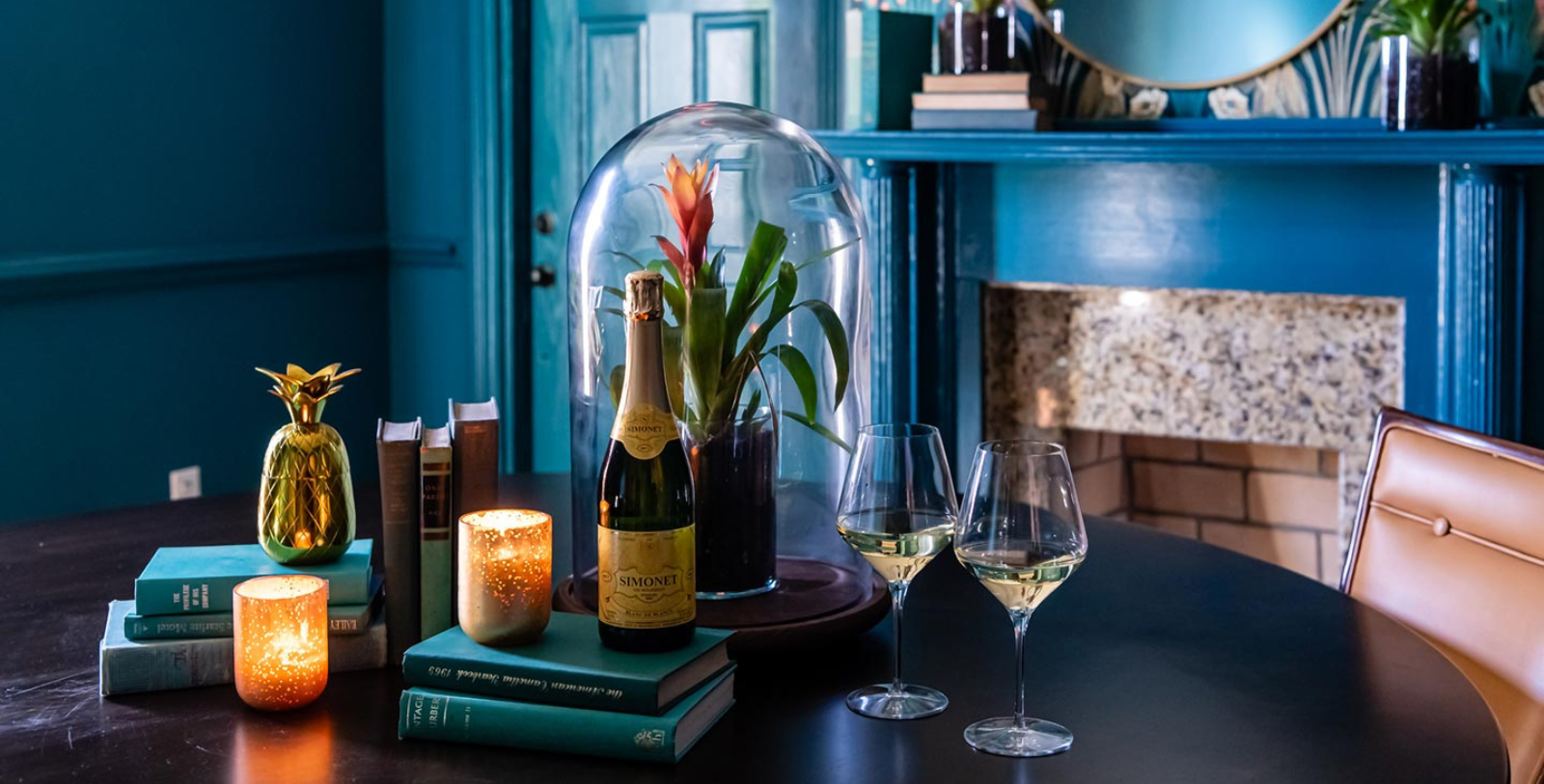a wine glass and a bottle on a table