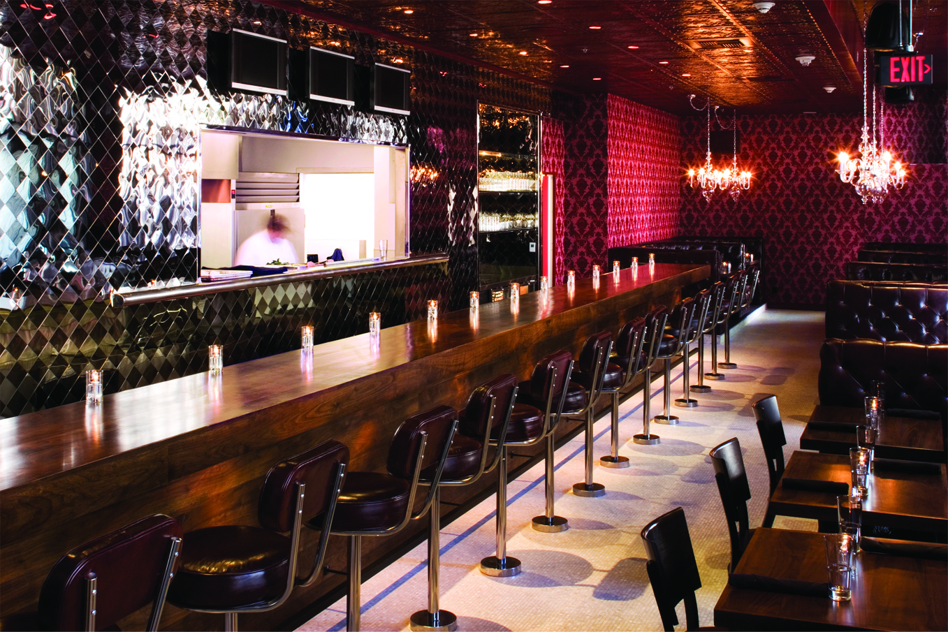 a long bar with chairs and tables
