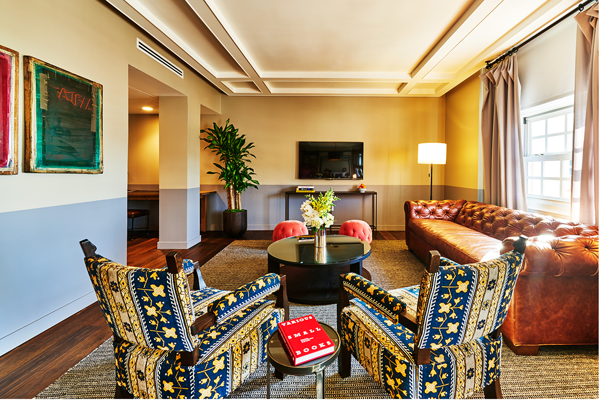 a room with a couch and chairs