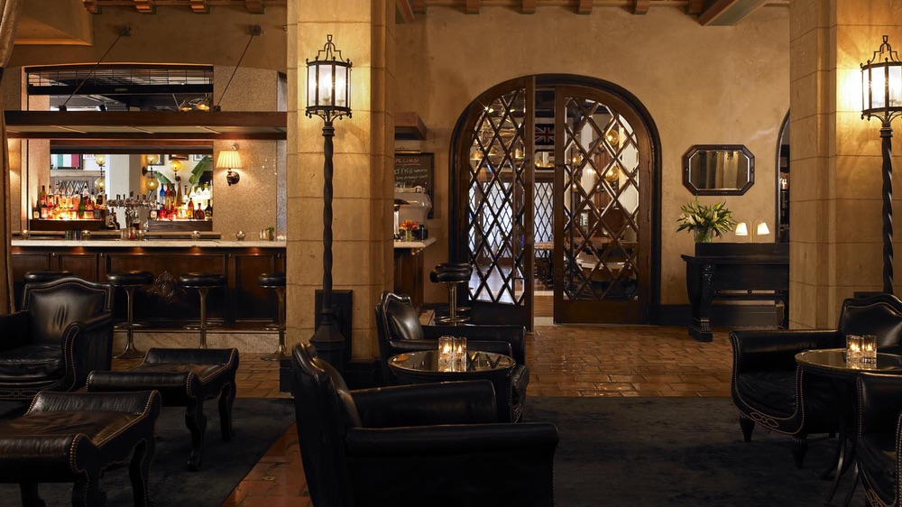 a room with a bar and chairs