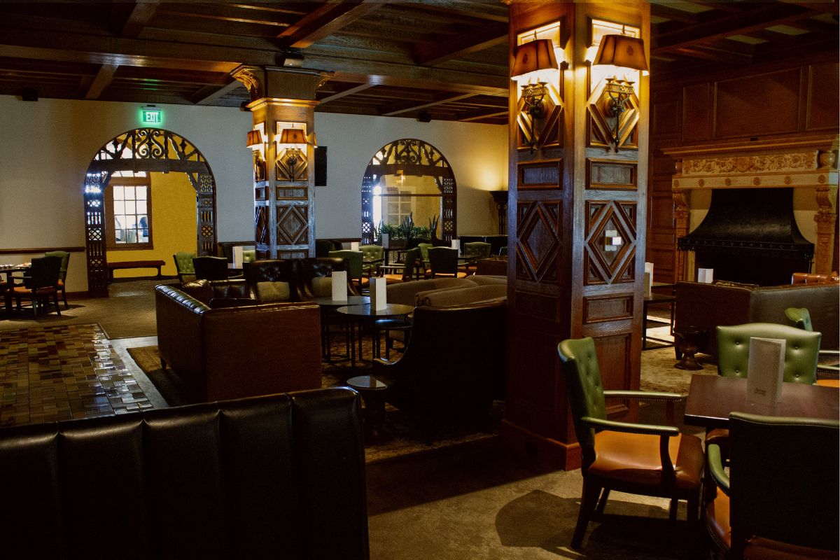 a room with a large column and tables and chairs