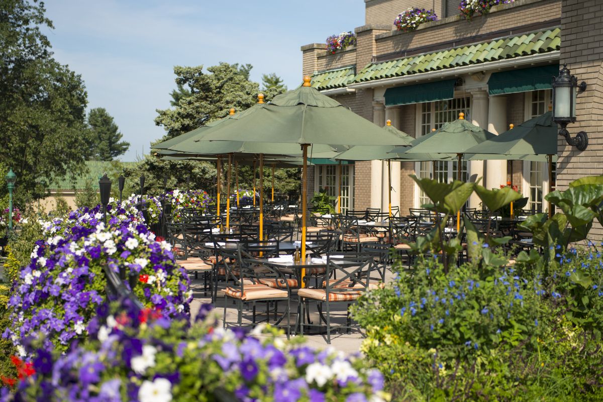 a patio with tables and umbrellas