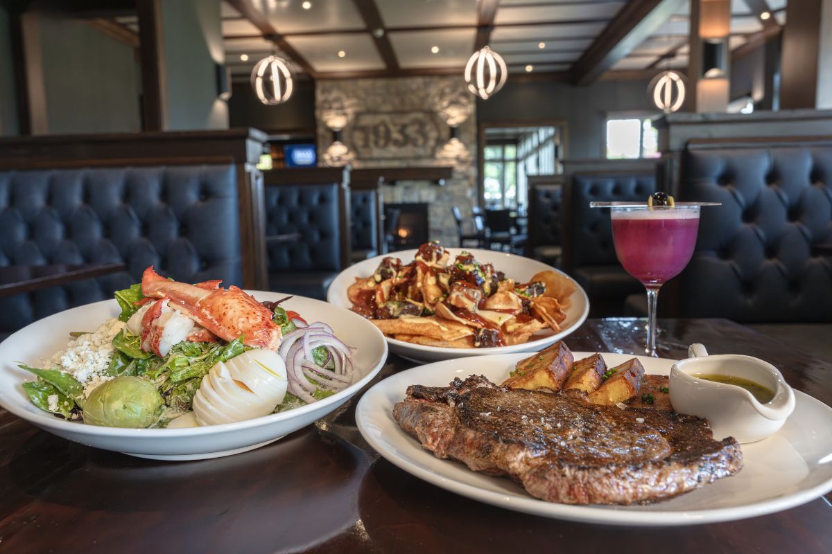 a table with plates of food and a drink