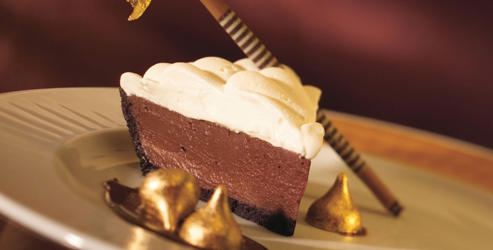 a piece of chocolate pie with a straw