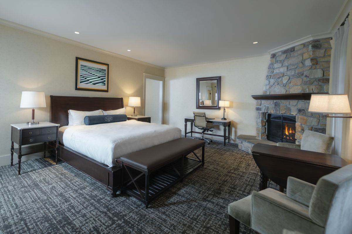 a room with a fireplace and a bed