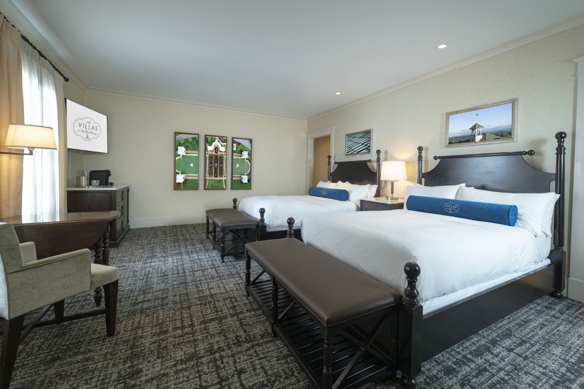 a room with two beds and a television
