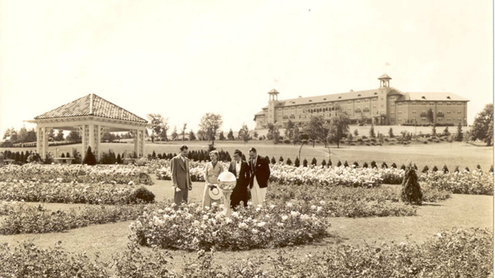 a group of people standing in a garden