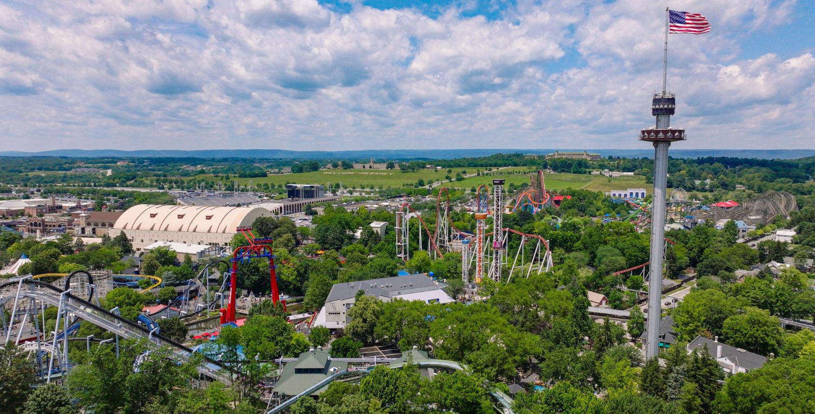 a park with roller coasters and trees