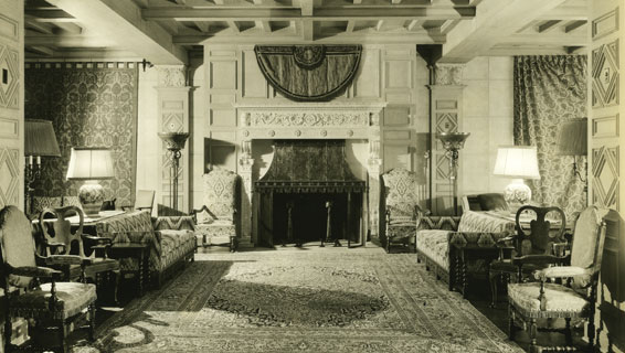 a room with a fireplace and chairs