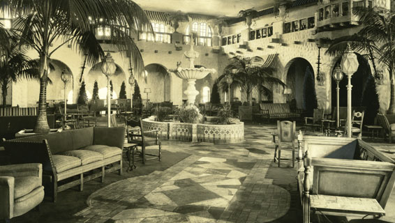 a room with a fountain and chairs