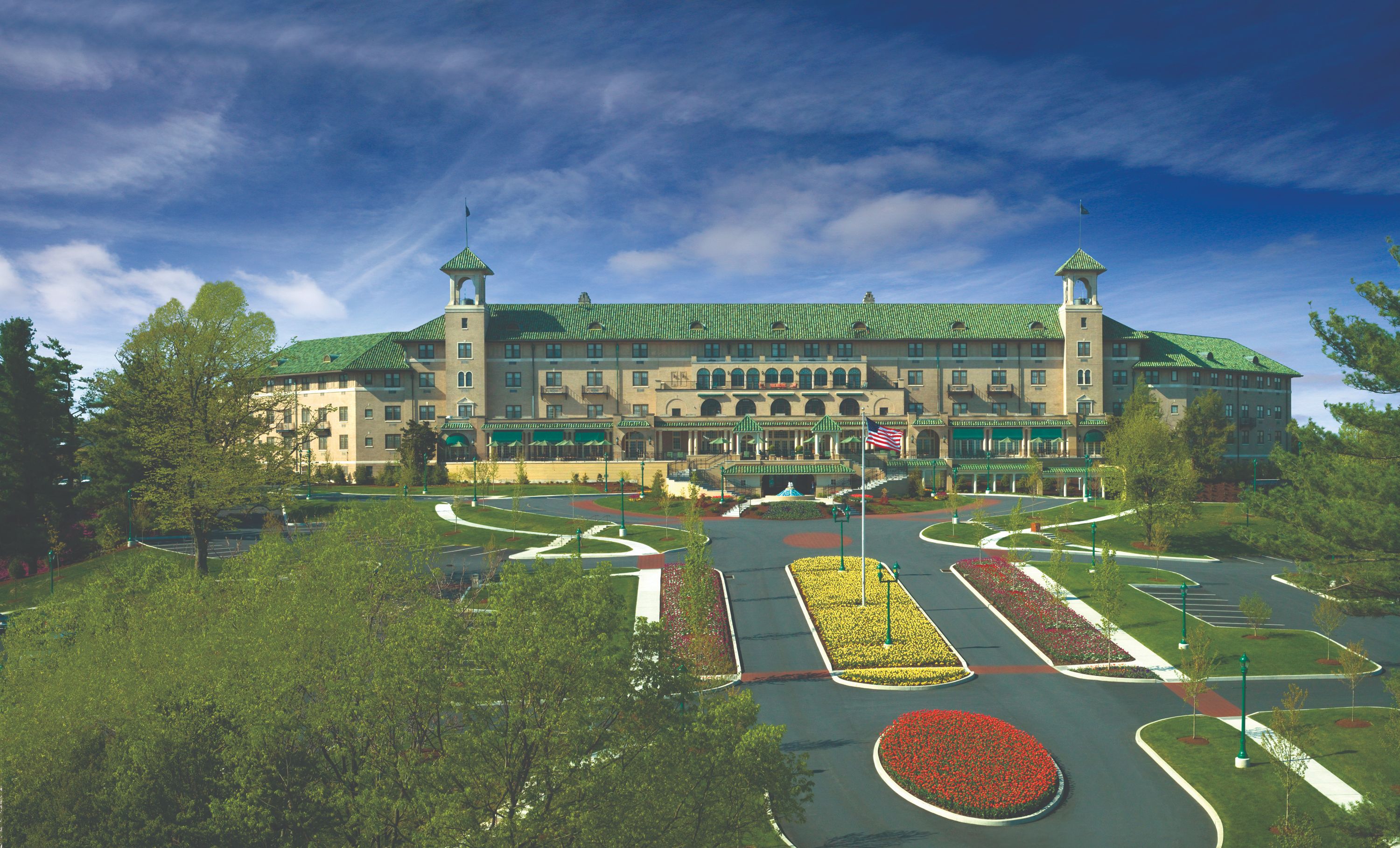 a large building with a lawn and flowers