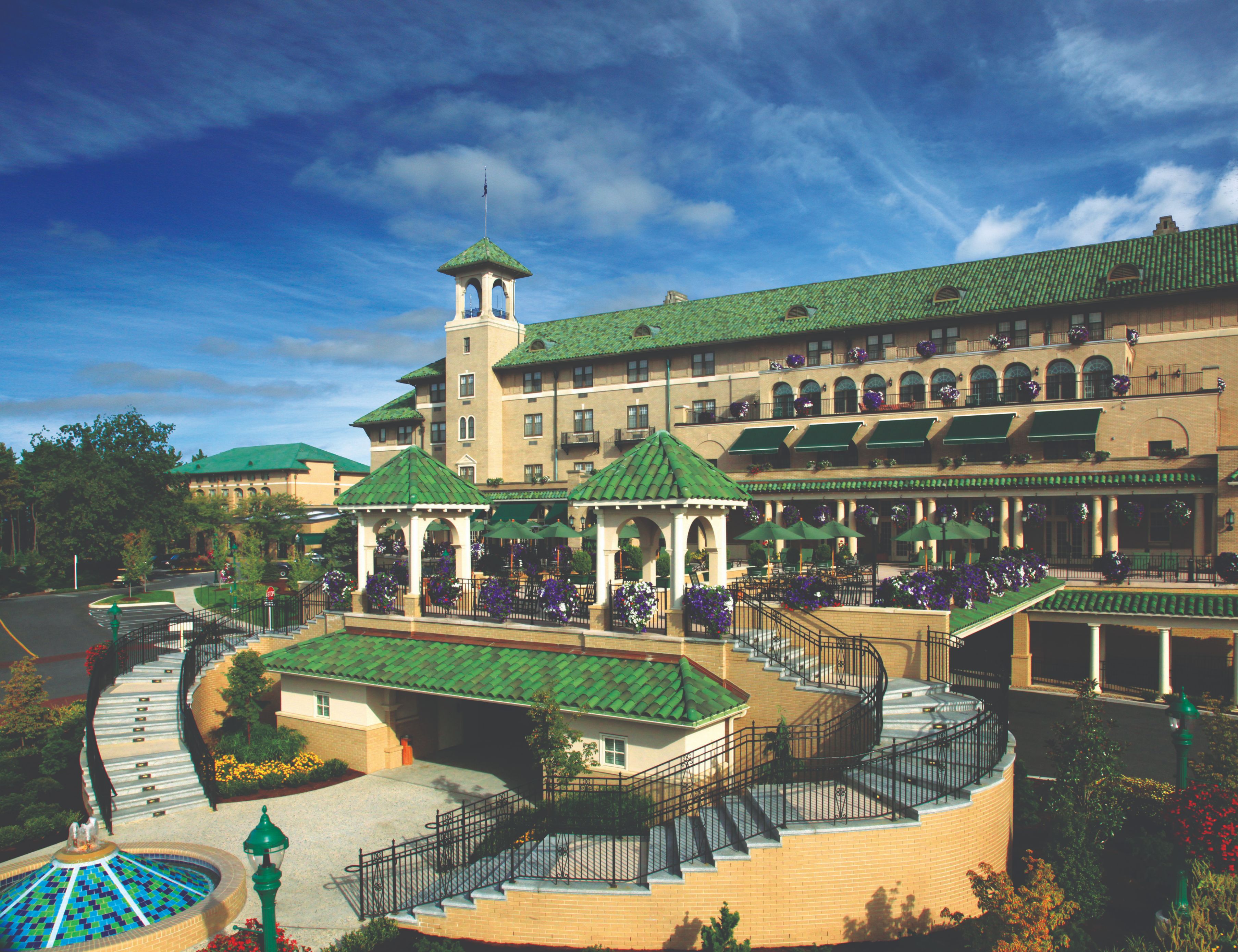a large building with green roofs with The Hotel Hershey in the background