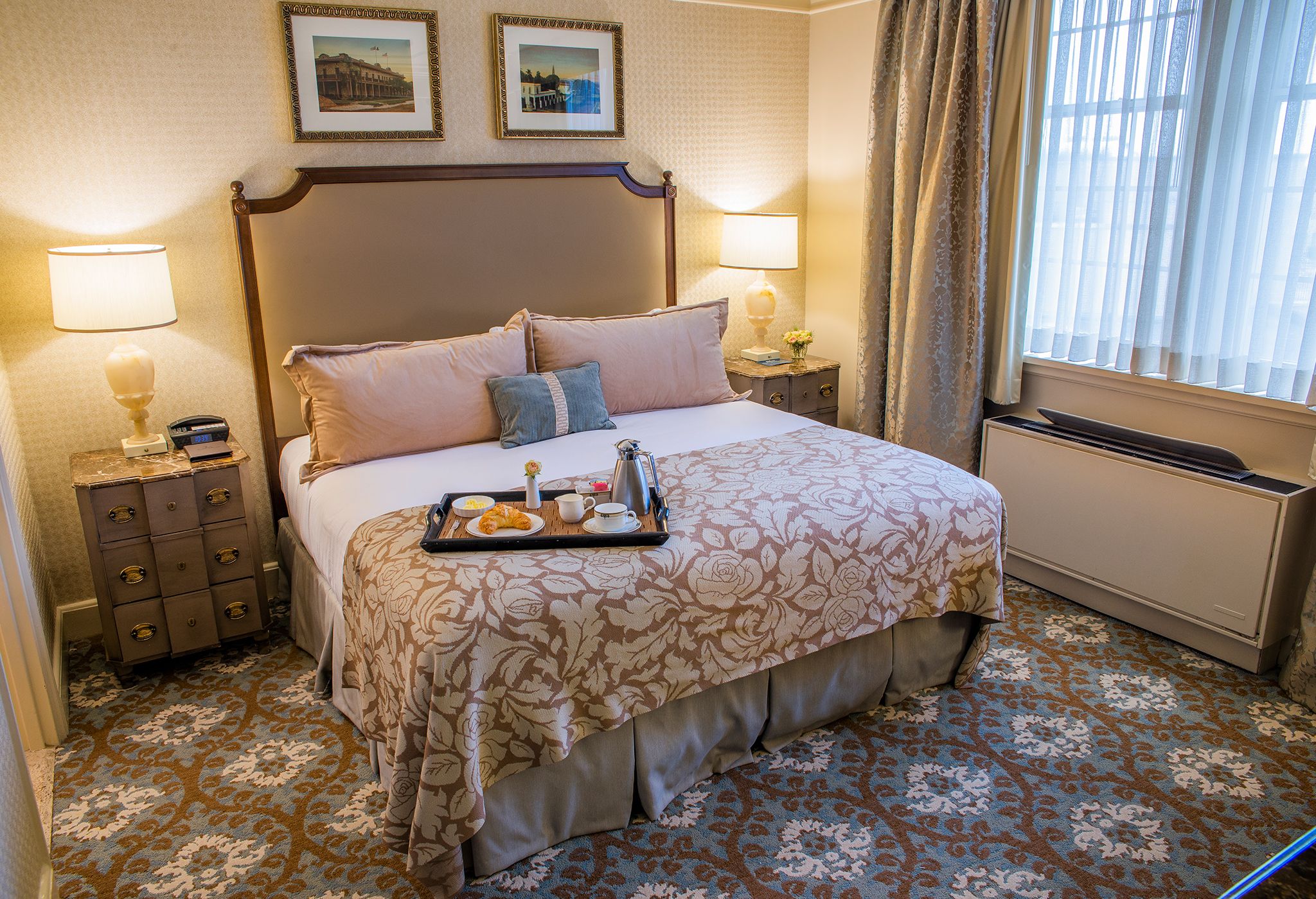 a tray of food on a bed in a hotel room