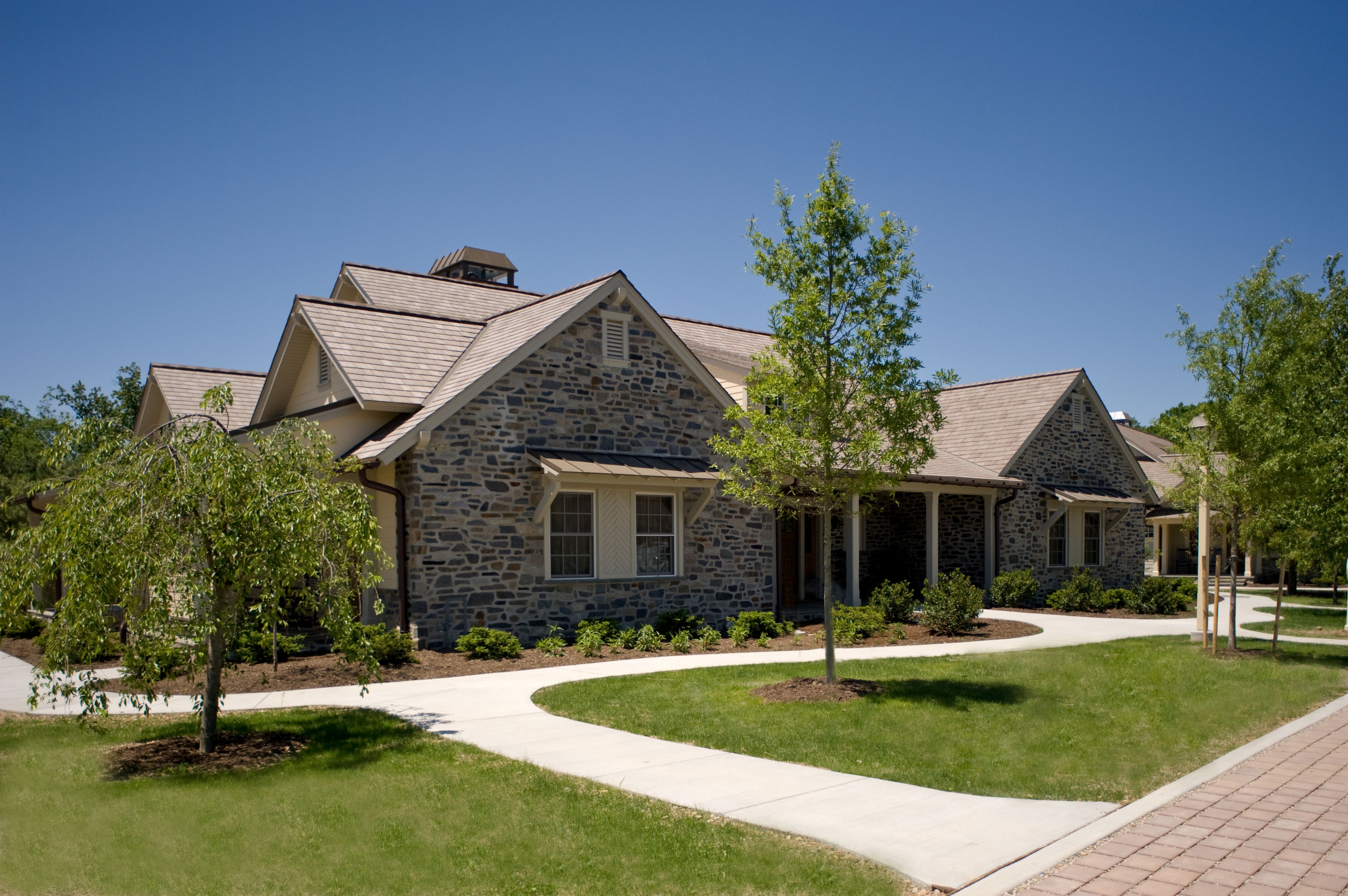 a house with a lawn and a walkway