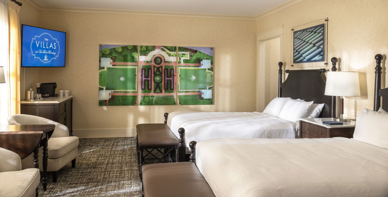 a room with two beds and a painting on the wall