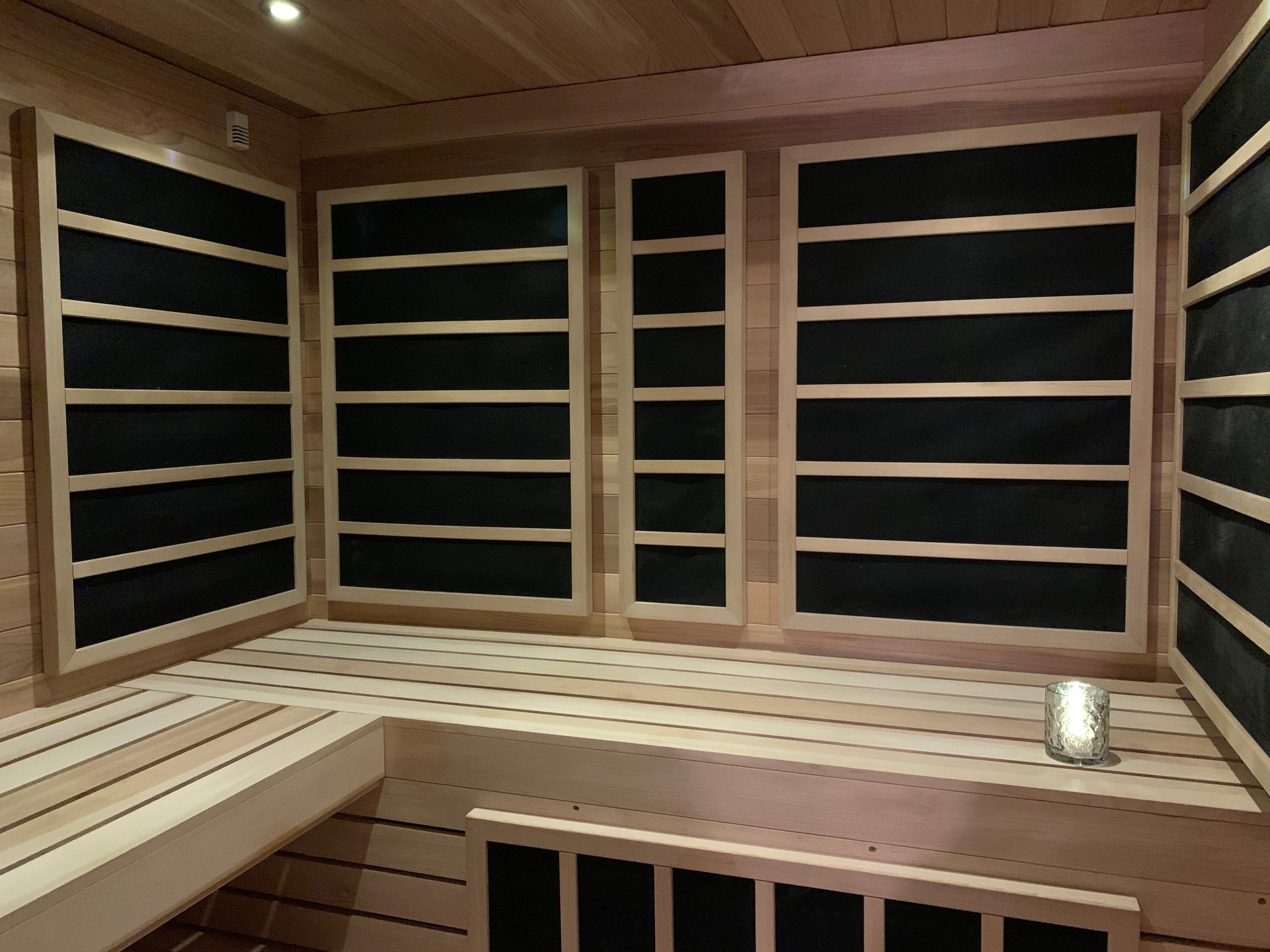 a wooden sauna with black shelves