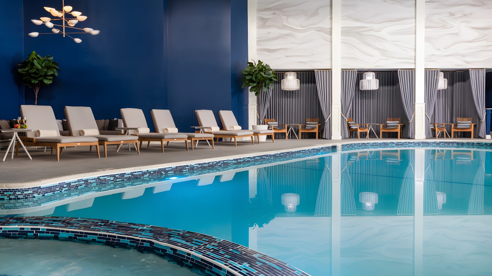 a pool with chairs and a plant