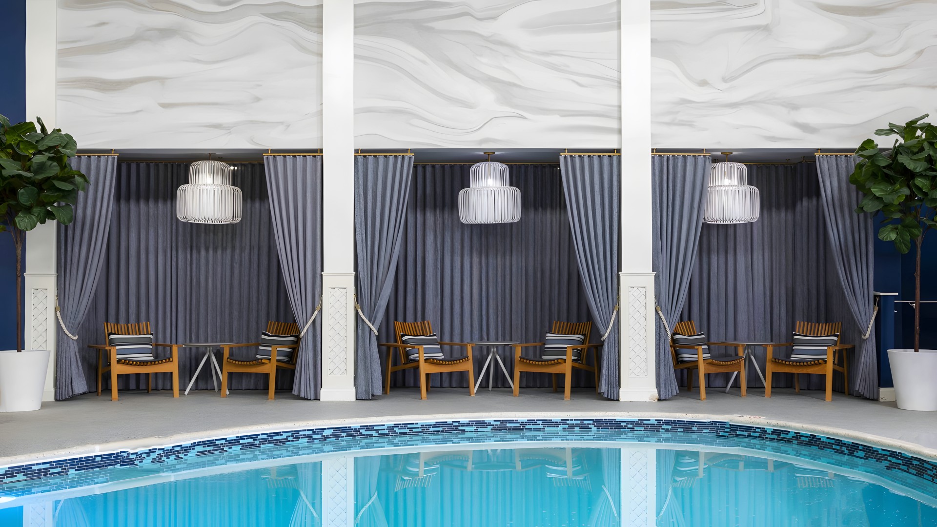 a swimming pool with chairs and tables