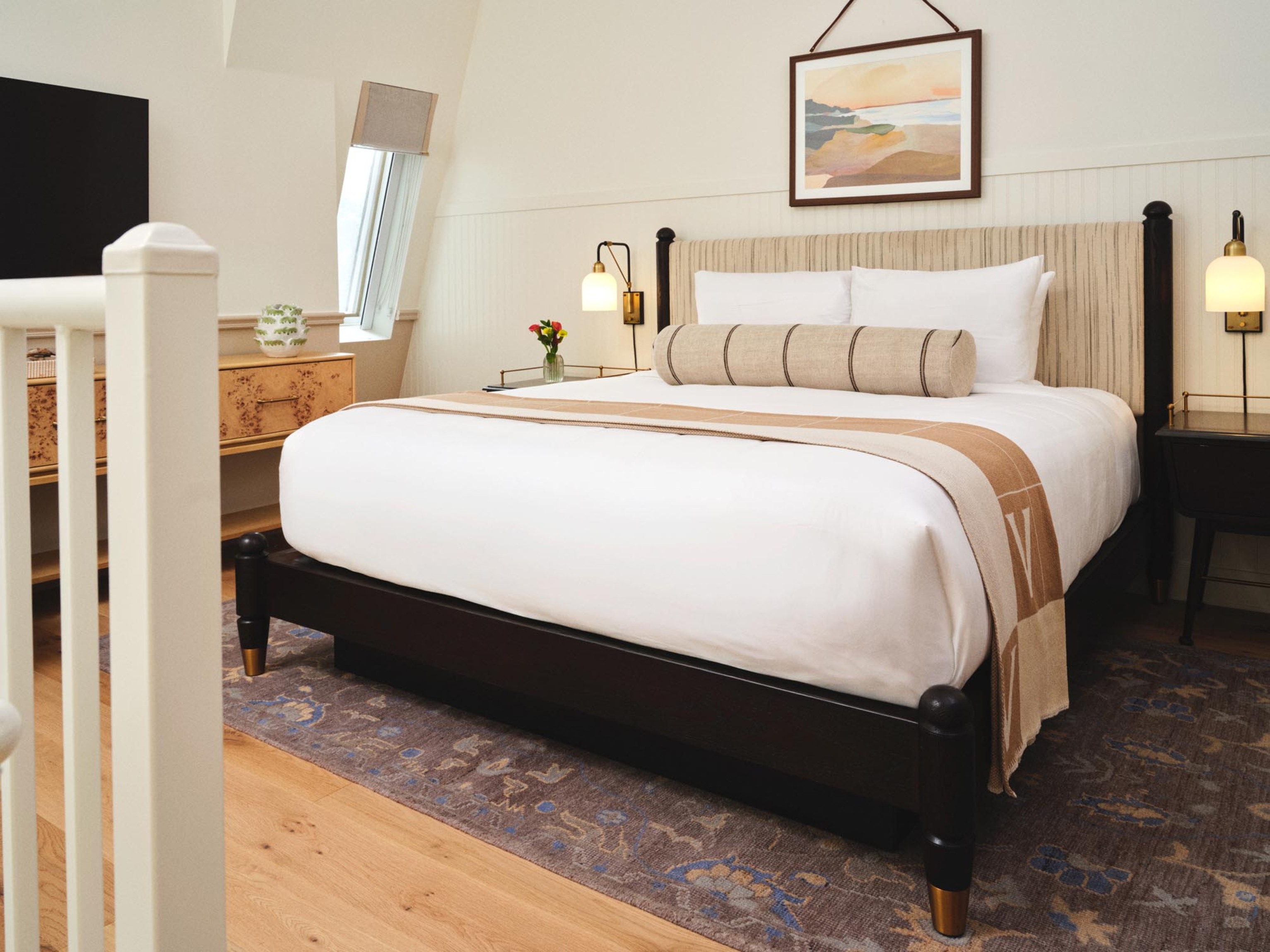 a bed with a lamp on the side