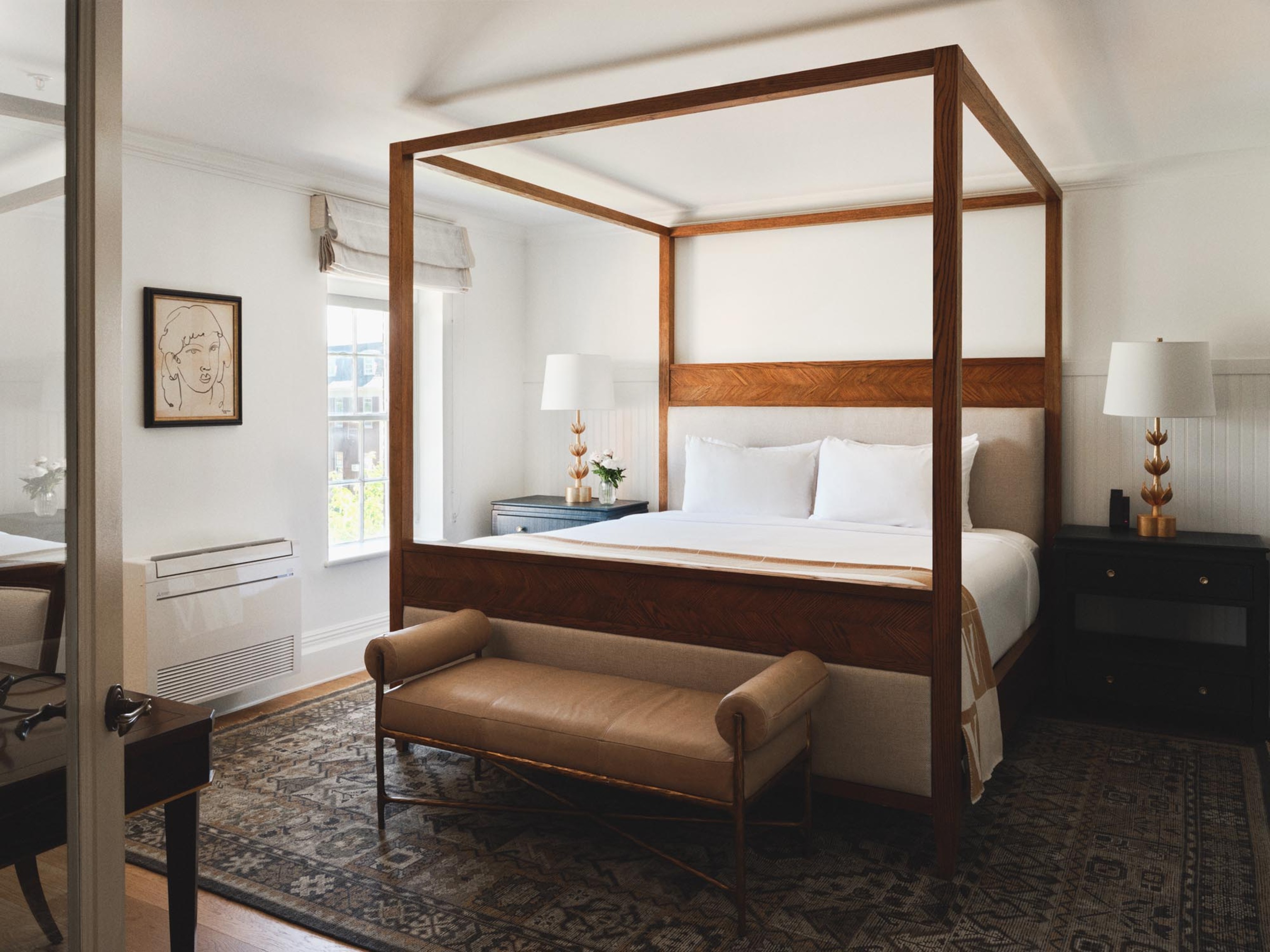 a bed with a bench in a room