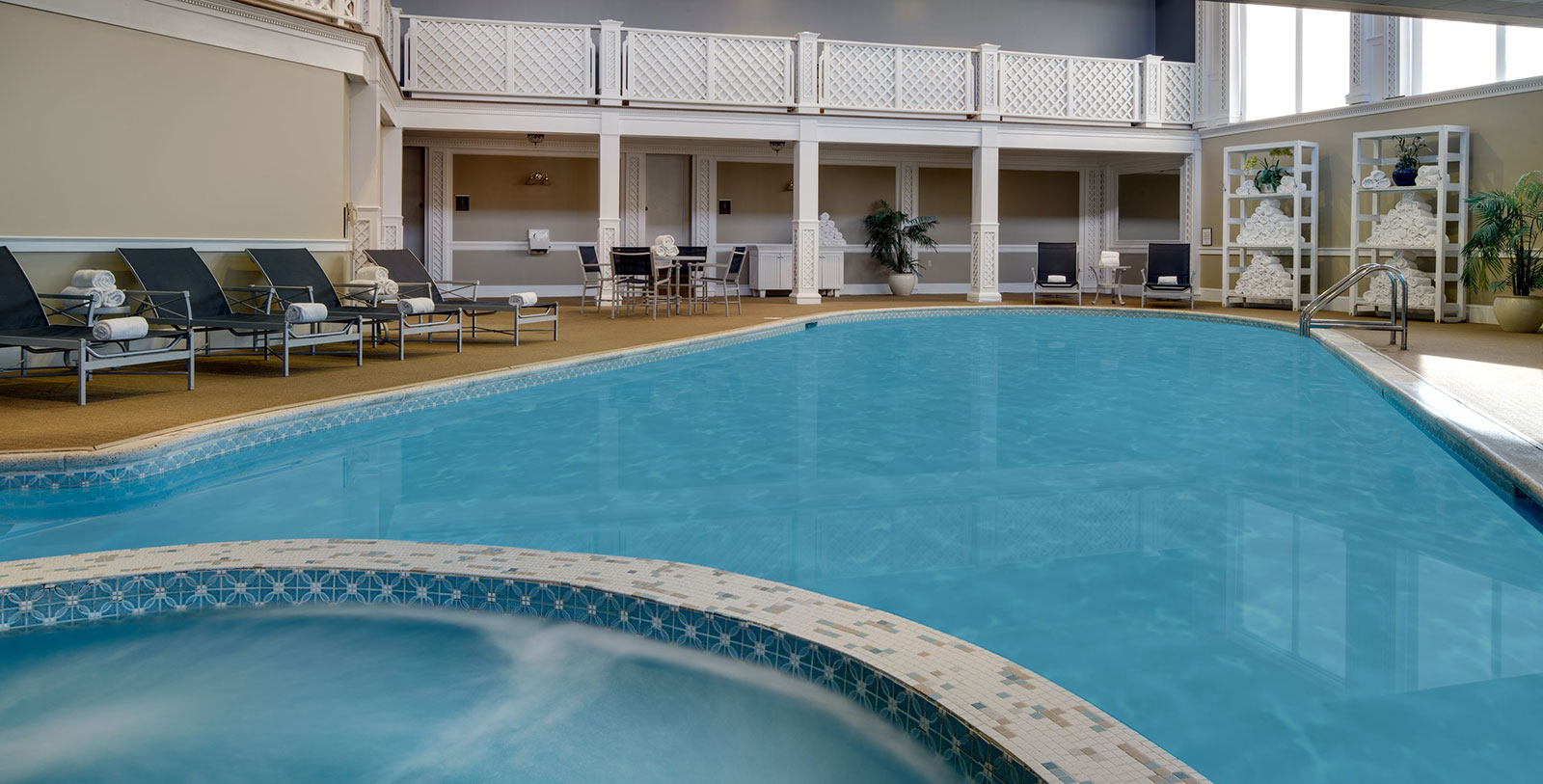 a swimming pool with chairs and a deck