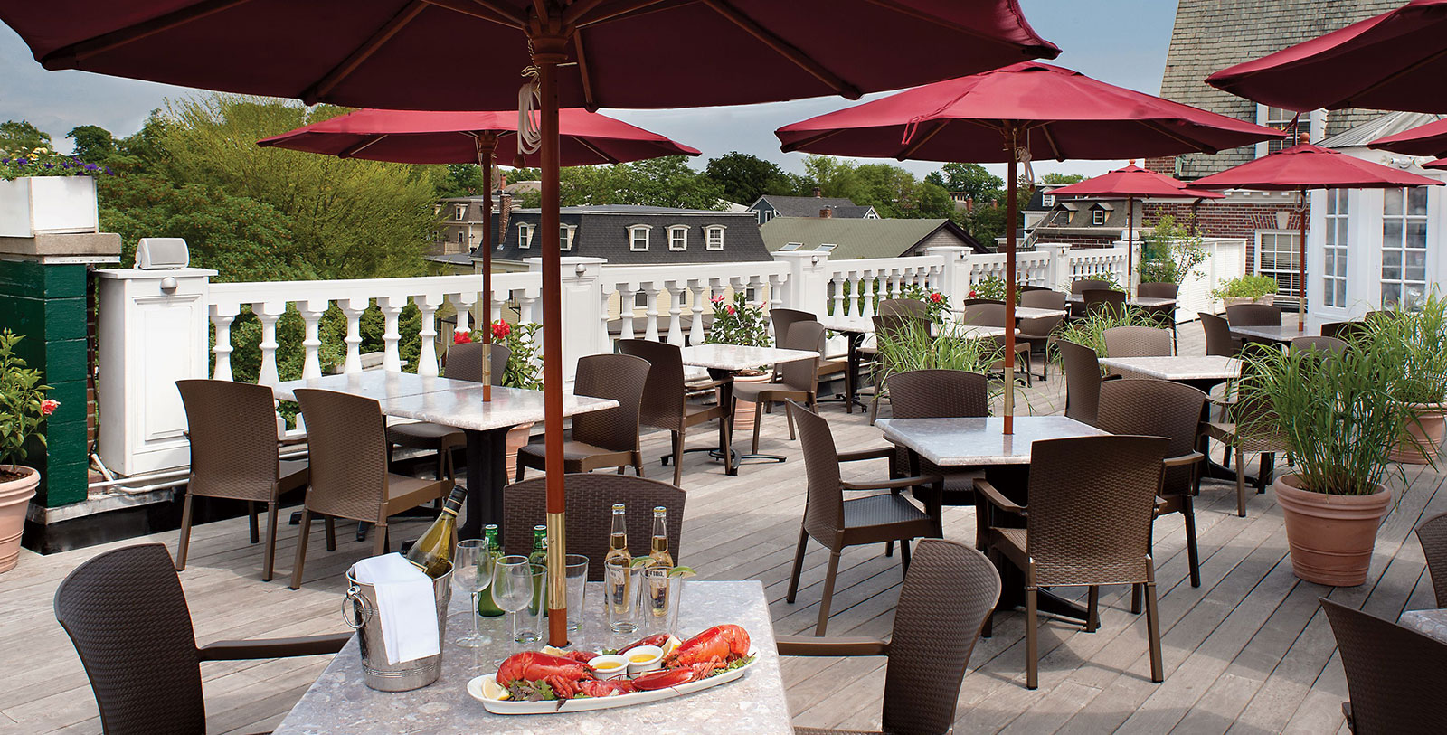a table and chairs with umbrellas on a deck