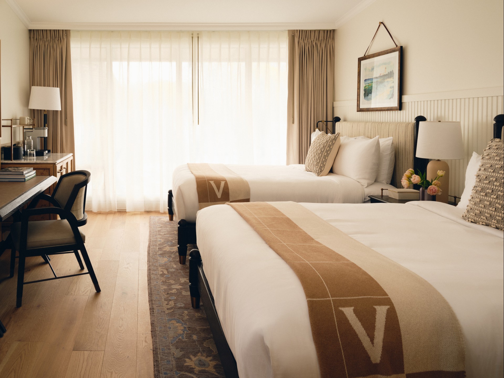 a room with two beds and a chair