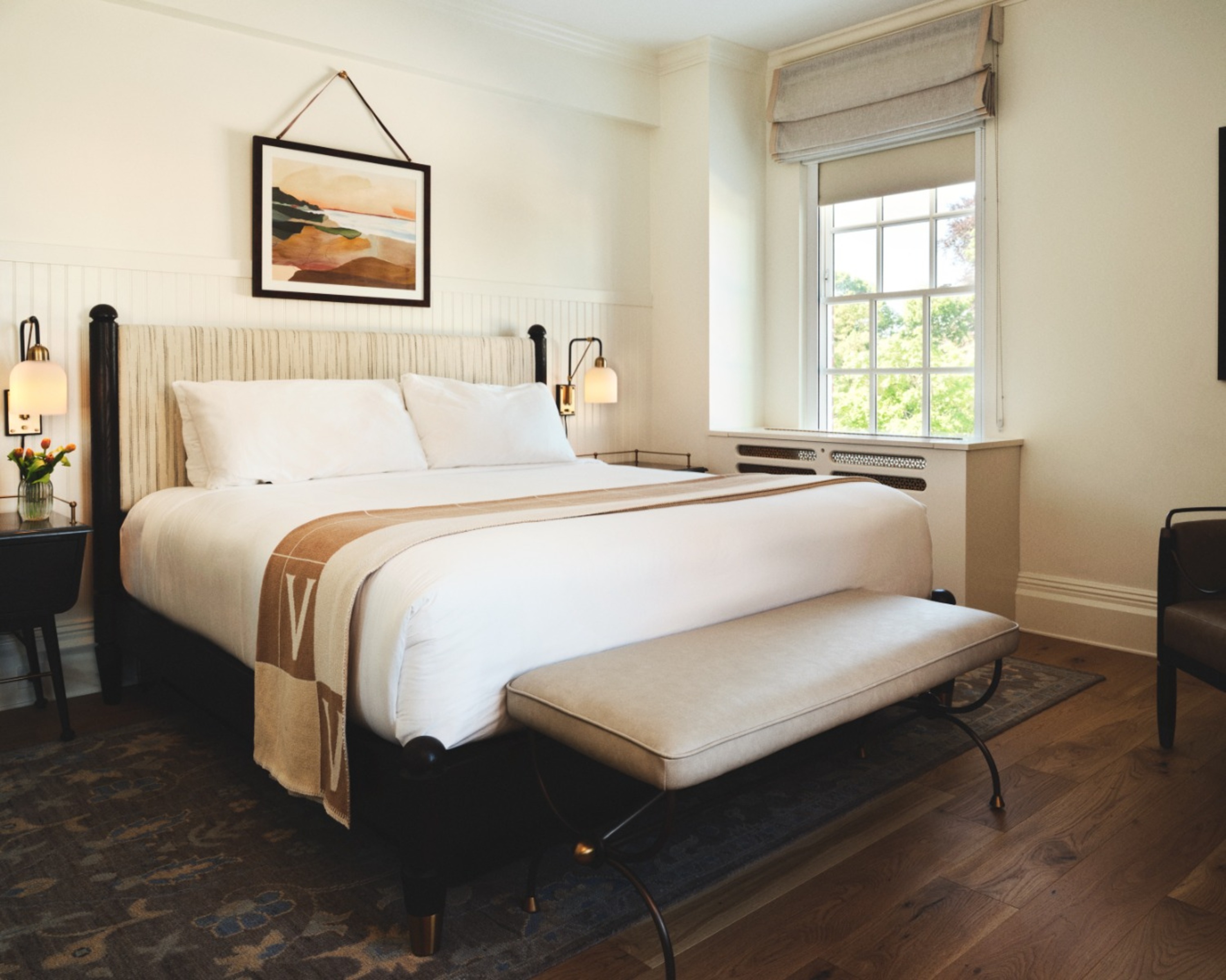 a bed with a bench in a room