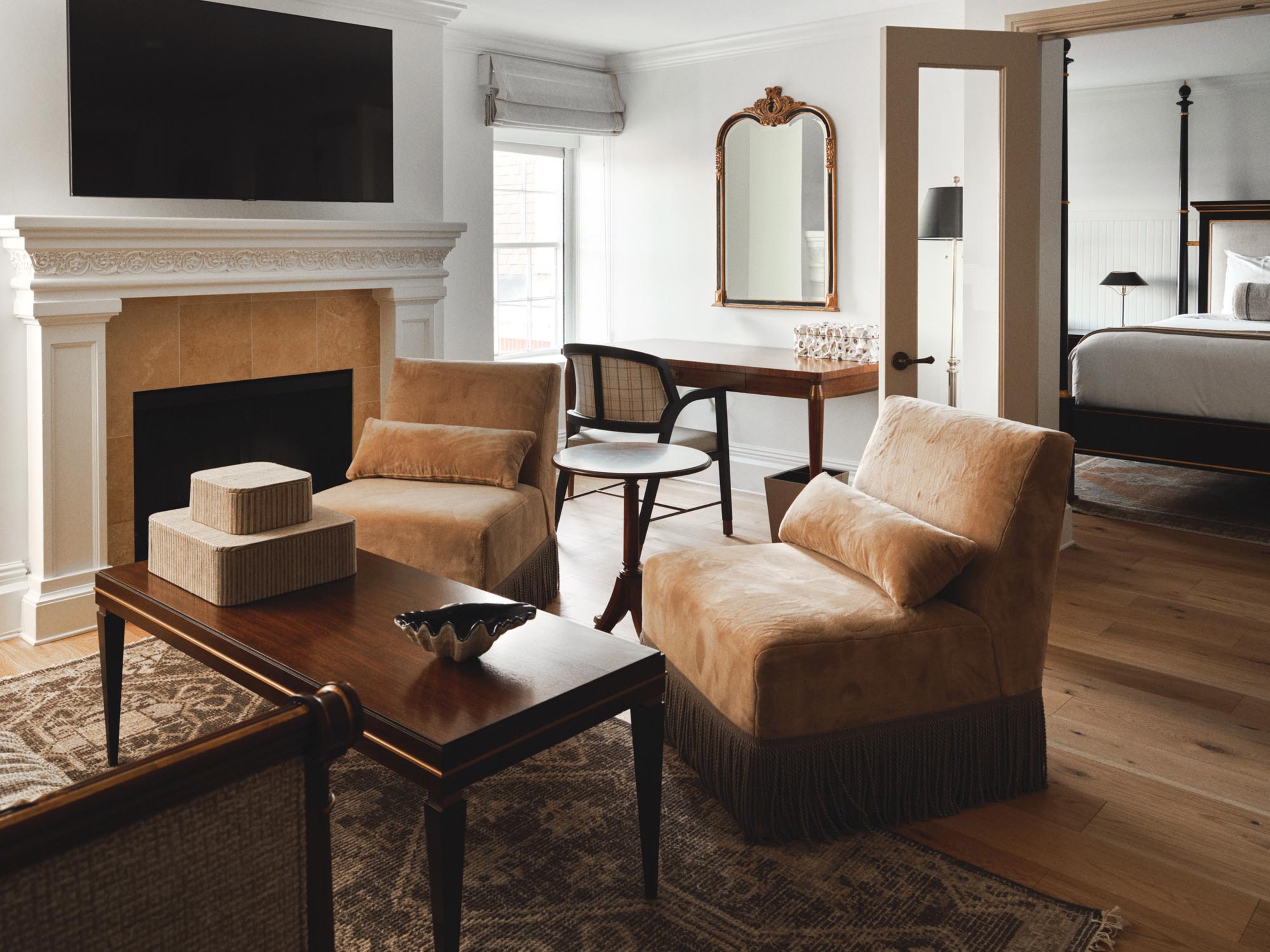 a living room with a fireplace and chairs