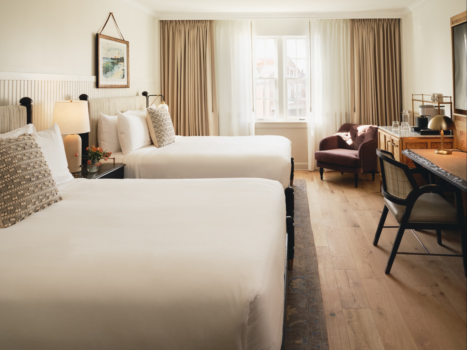 a room with two beds and a desk