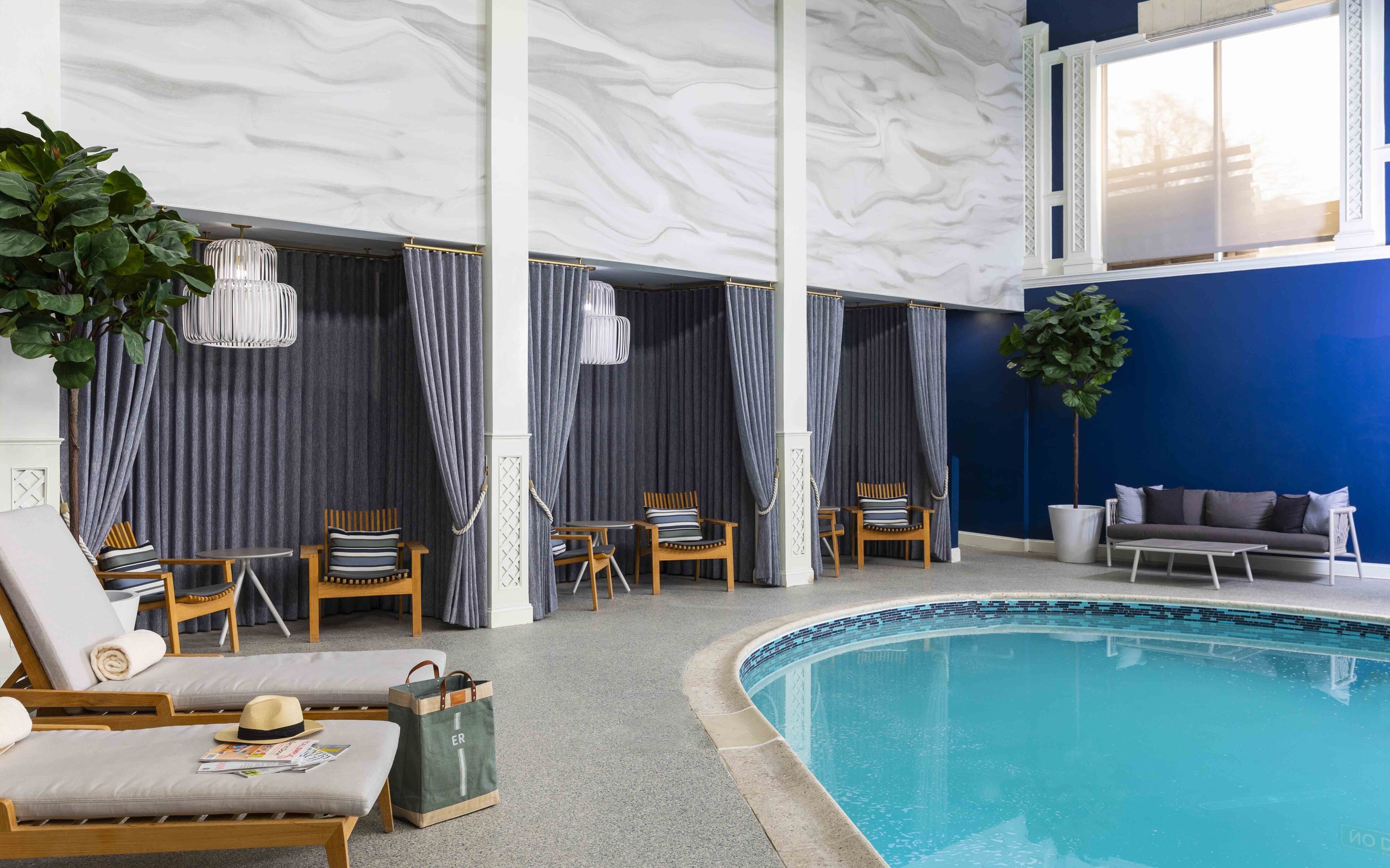 a swimming pool with chairs and a hat