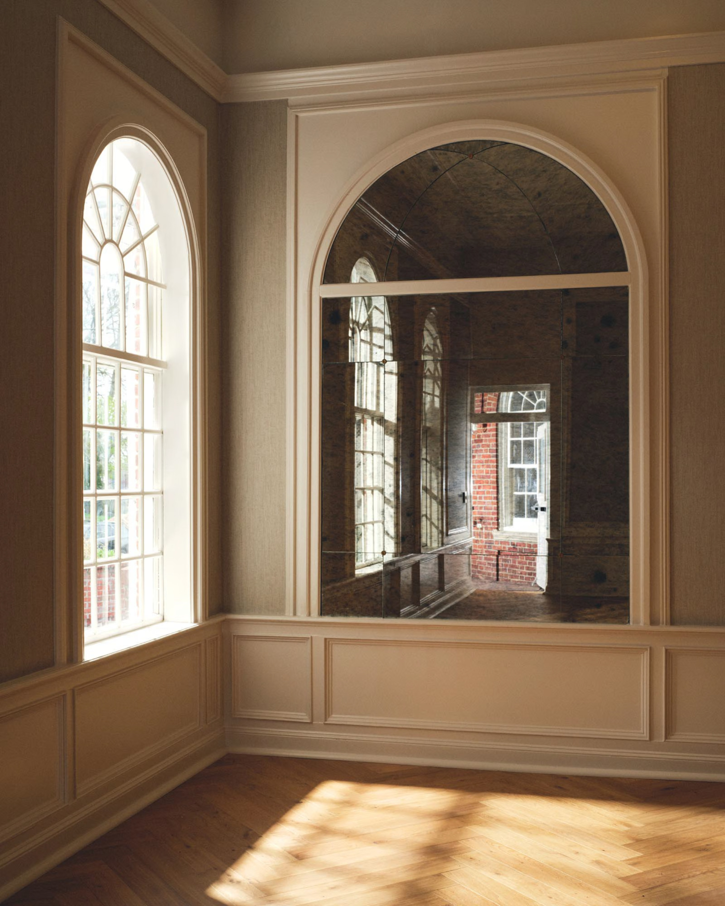 a room with arched windows and a brick building