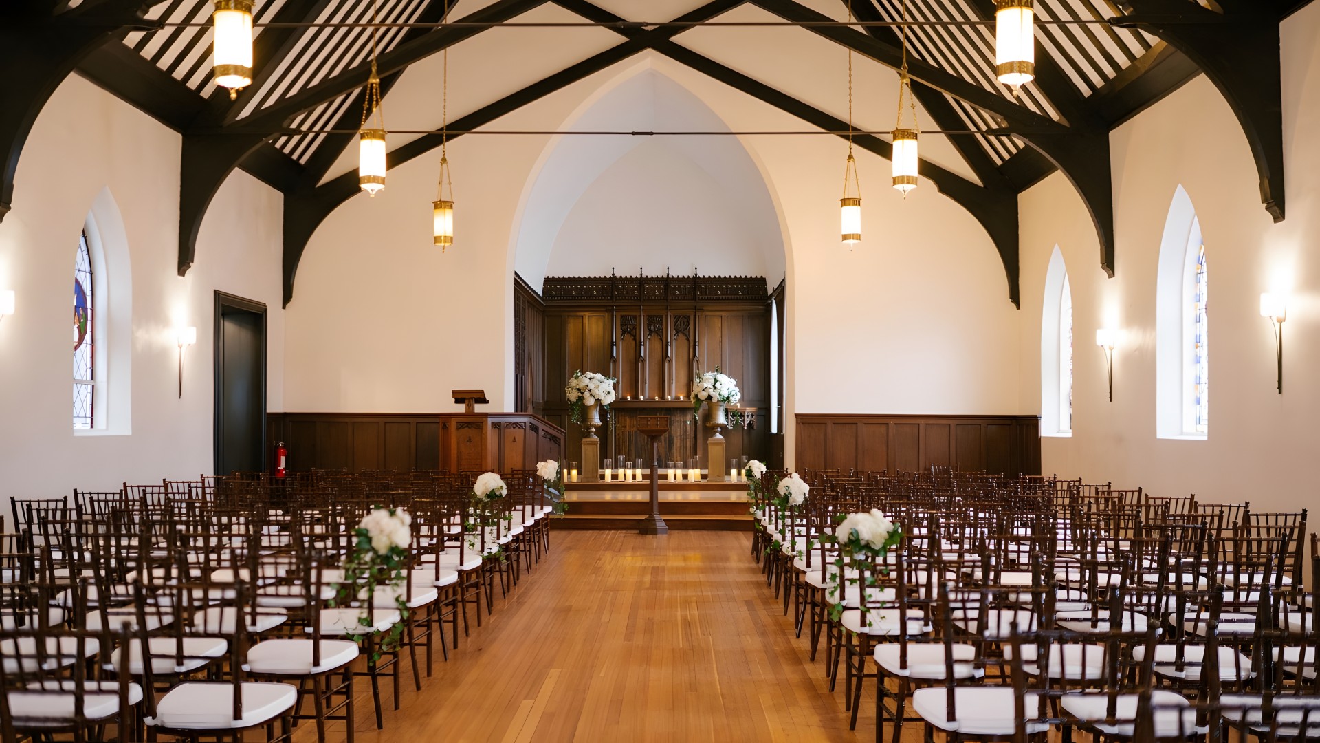 a room with chairs and candles