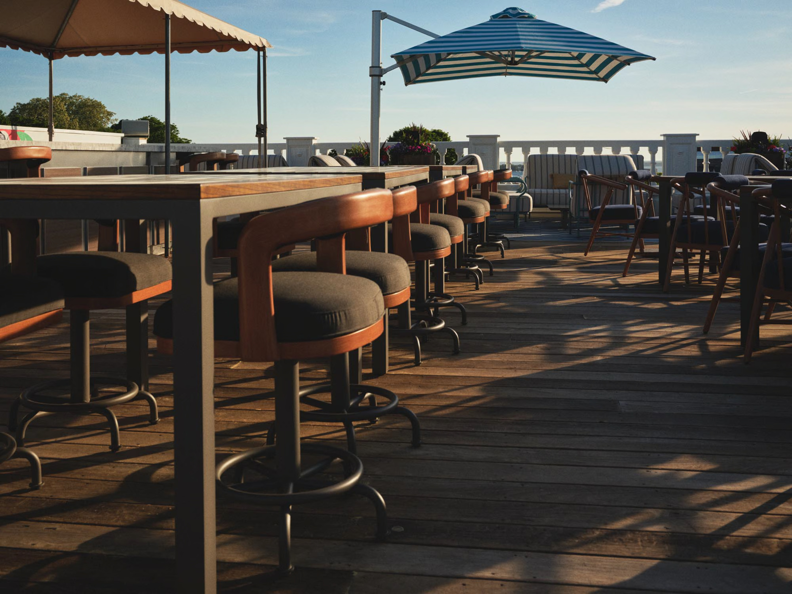 a patio with chairs and umbrellas