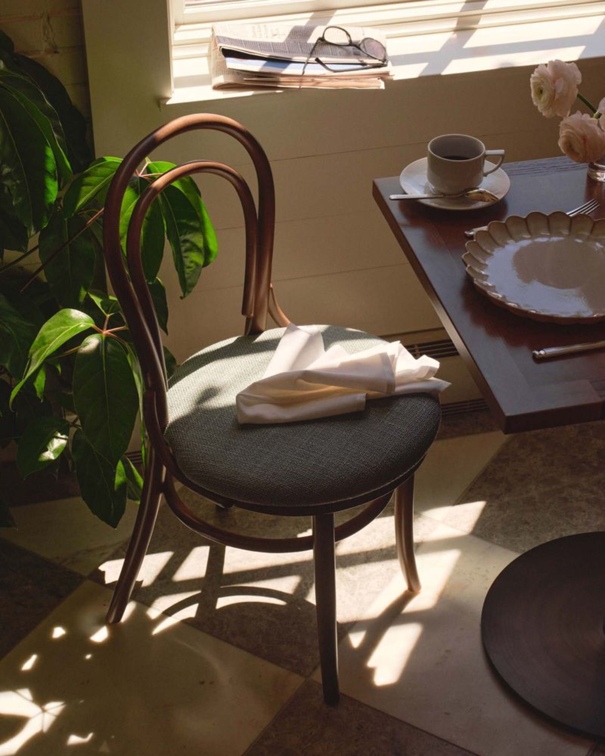 a chair and a table with a plate and a plate on it