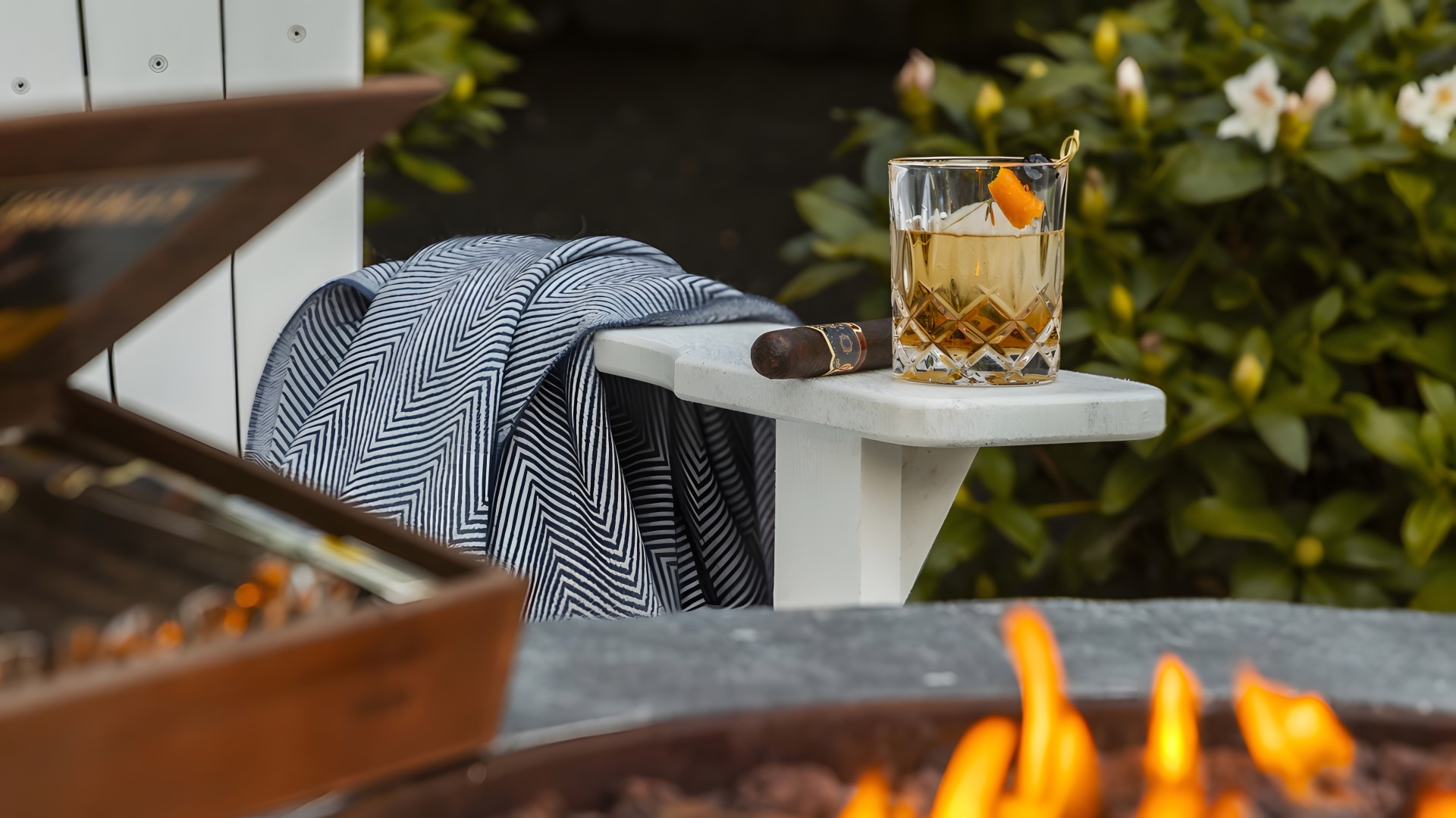 a glass of whiskey and cigar on a table