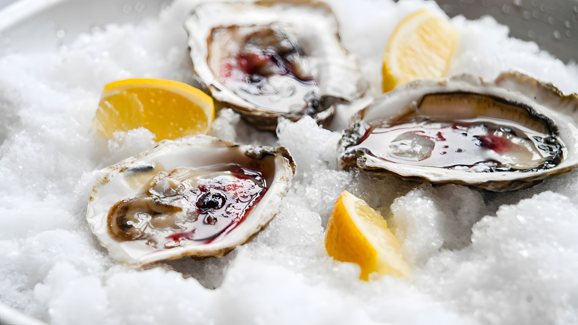 a oysters on ice with lemon slices