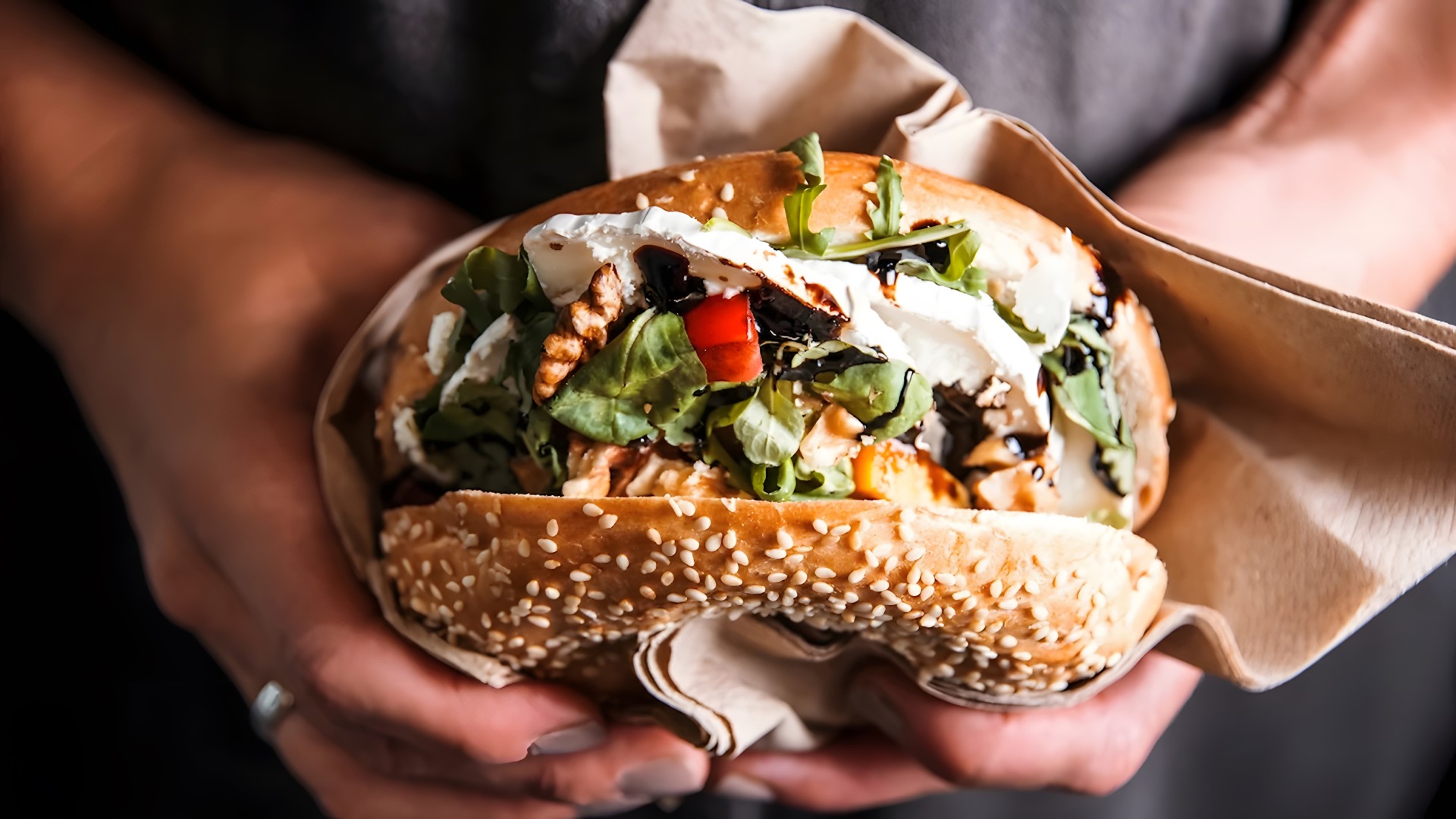 a person holding a sandwich
