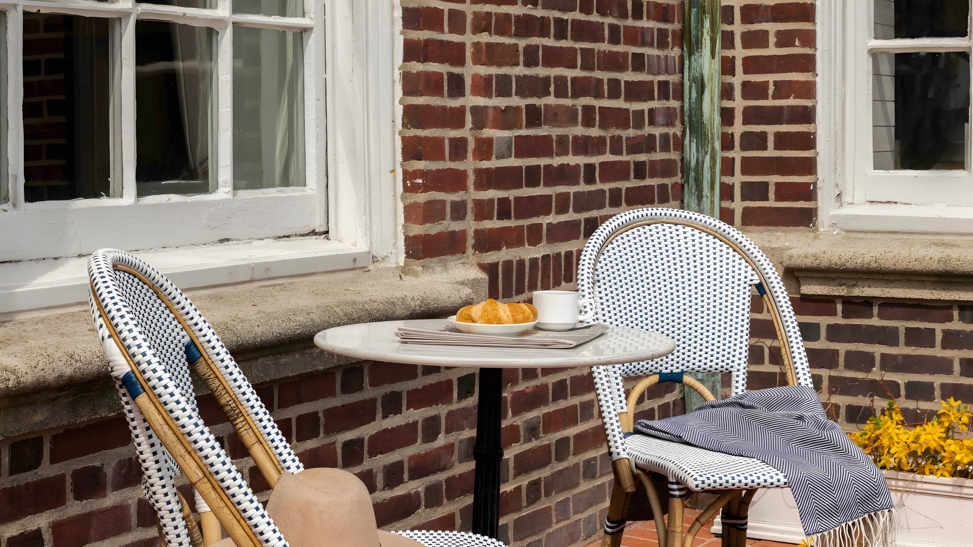 a table with a plate of food and a cup of coffee on it