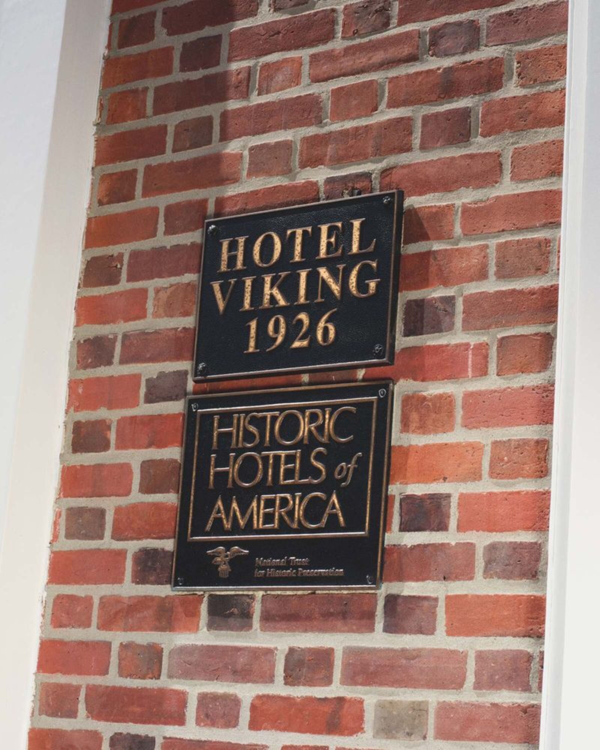 a sign on a brick wall